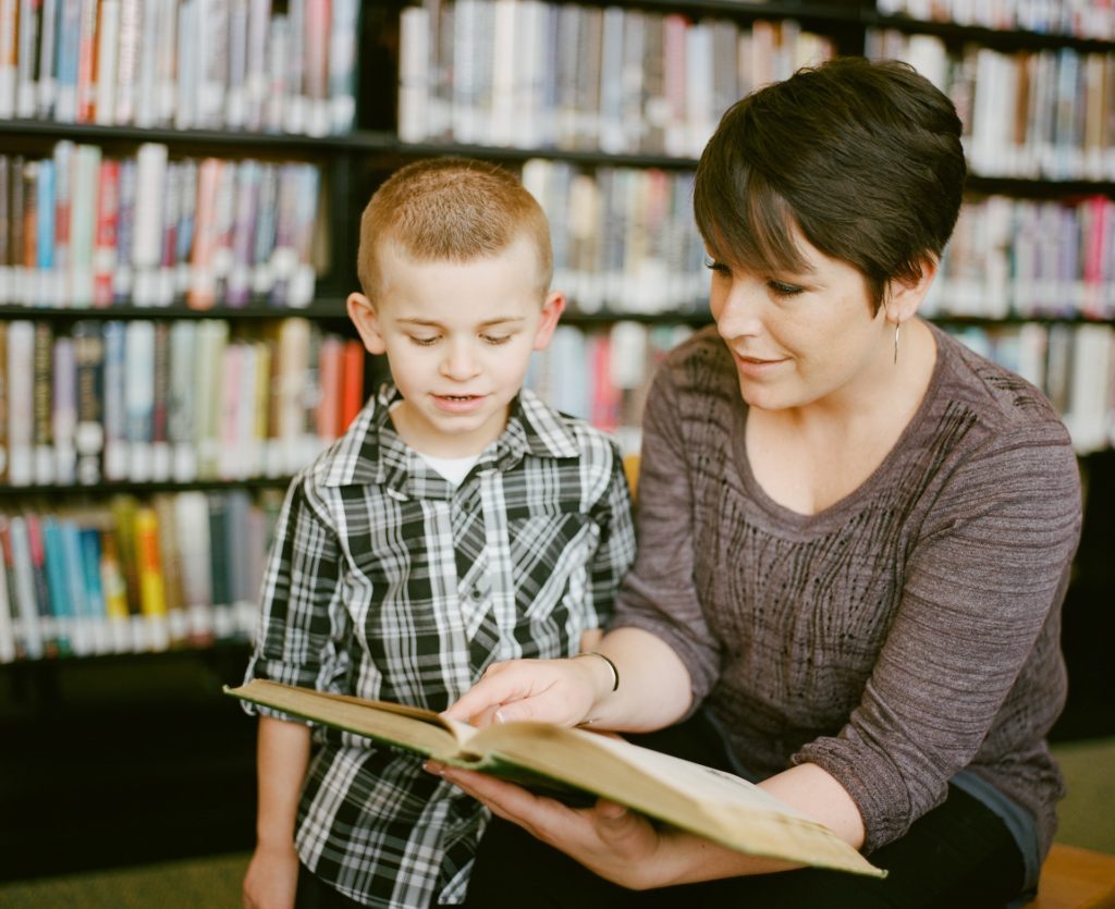 homeschool mom son library unsplash adam winger